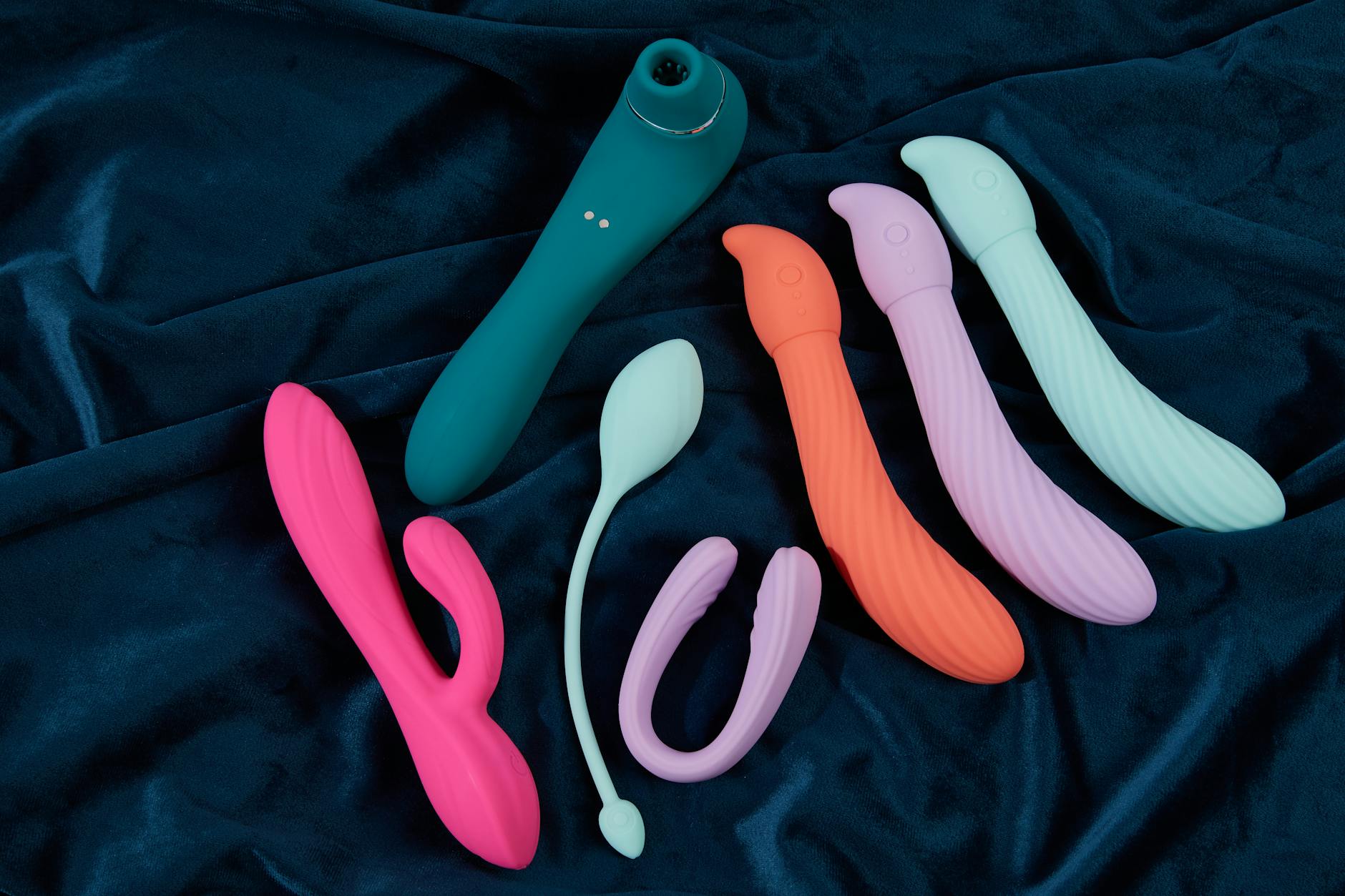 Vibratore in silicone giallo circondato da banane su sfondo giallo, simbolo di piacere fresco e vivace