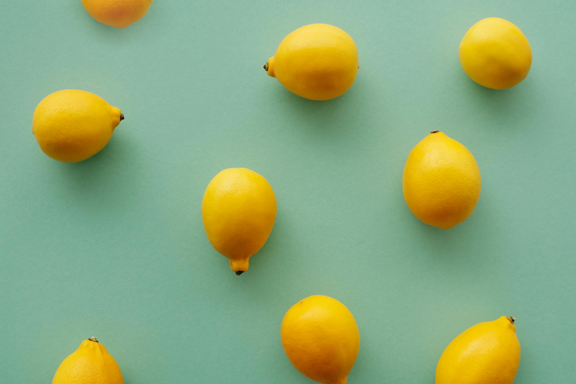 Bright yellow lemons arranged on a pastel background, symbolizing freshness and natural arousal support